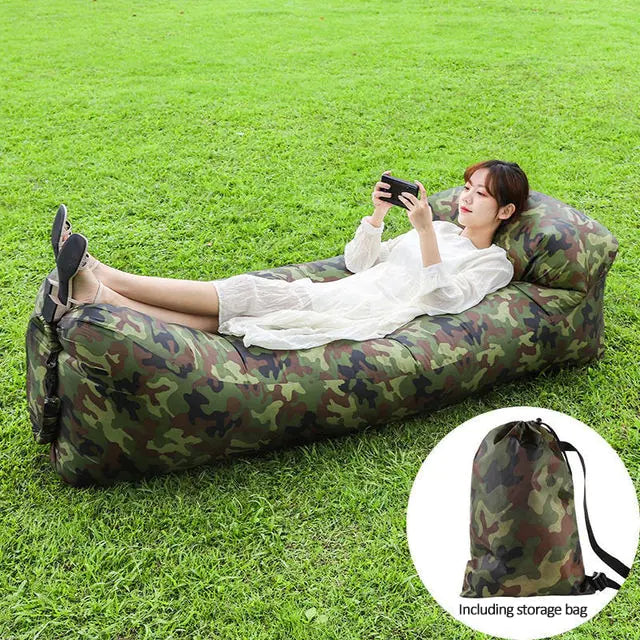 Camo Relax™ Inflatable Sofa Bed with a woman lounging and a storage bag included. Perfect for outdoor relaxation, camping, and travel.