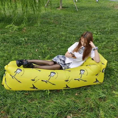 Yellow Relax™ Inflatable Sofa Bed with a unique print, used outdoors. Comfortable and easy to inflate, ideal for various settings.