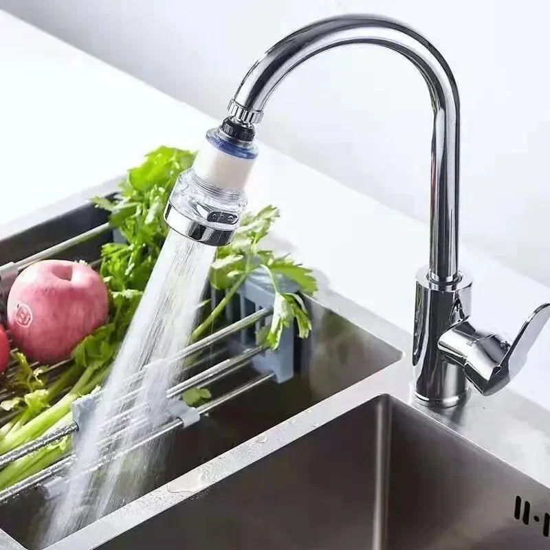 AquaPure™ 360° Tap Water Purifier attached to a modern kitchen sink, delivering a filtered water stream for washing produce.