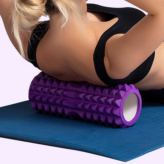 Fitclub™ Foam Massage Roller in purple used for back massage on a yoga mat, designed for deep tissue muscle relief.